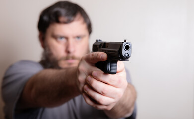 Man Aiming a Handgun with Intense Focus and Determination