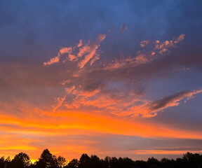 Naklejka premium dark blue sky with orange sunset clouds