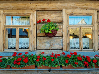 fragment wooden house built  in traditional style with flowers. Poland