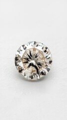 Round diamond with sparkling facets isolated on blurred white background
