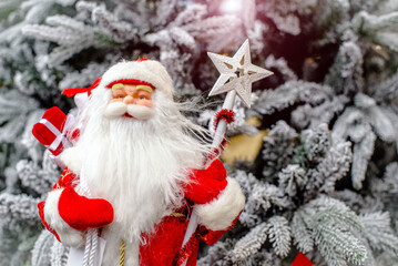 Santa Claus with gifts on the background of the Christmas tree 