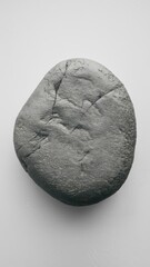 Gray rock on white background with minimal design elements