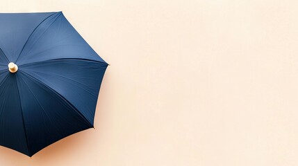   Overhead view of blue umbrella on beige background with white spot on top