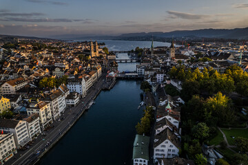Obraz premium Beautiful aerial view of the city of Zurich in Switzerland - the Limmat River and its iconic churches, buildings rivers and Clockes.