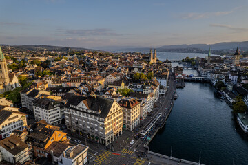 Beautiful aerial view of the city of Zurich in Switzerland - the Limmat River and its iconic churches, buildings rivers and Clockes.