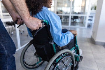 Obraz premium Disabled African American woman in wheelchair in modern office