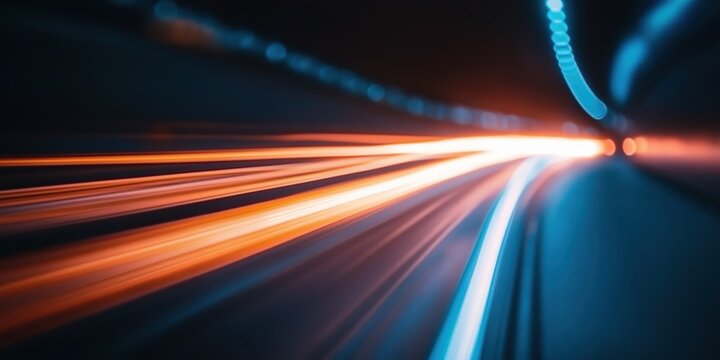 Speeding light trails in blue and orange with a motion blur futuristic highway technology concept