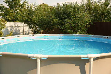 Above ground swimming pool outdoors on sunny day