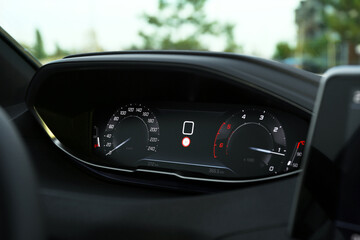 Speedometer on dashboard inside of modern luxury car, closeup