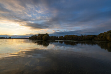 The sky is cloudy and the sun is setting