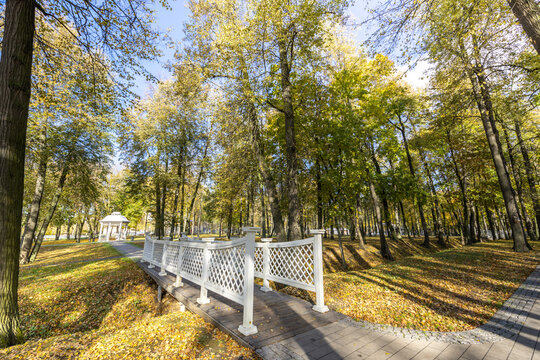 A park with a white fence and a gazebo