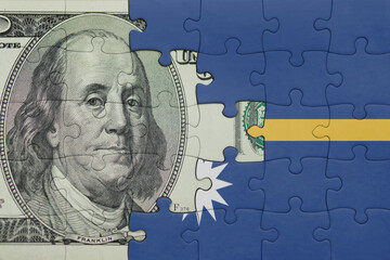 puzzle with the national flag of Nauru and the usa dollar money .finance concept