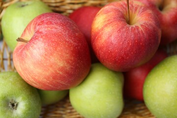 Many fresh ripe apples in basket, closeup