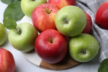 Fresh ripe apples on light grey table, closeup