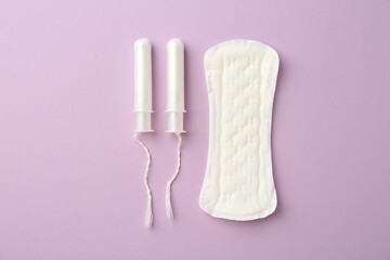Menstrual pad and tampons on lilac background, top view © New Africa