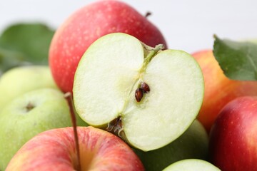 Different whole and cut ripe apples, closeup