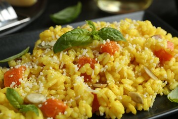 Delicious pumpkin risotto with parmesan and basil. closeup