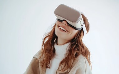 Fototapeta premium Smiling young pretty woman wearing a colored VR headset on a clean white background
