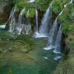 Obraz premium Plitvice Lakes National Park. Croatia. Big waterfalls. Nature travel background. Beautiful nature. Plitvice waterfalls in Croatia. Mountain streams flow into a lake with azure clear water.