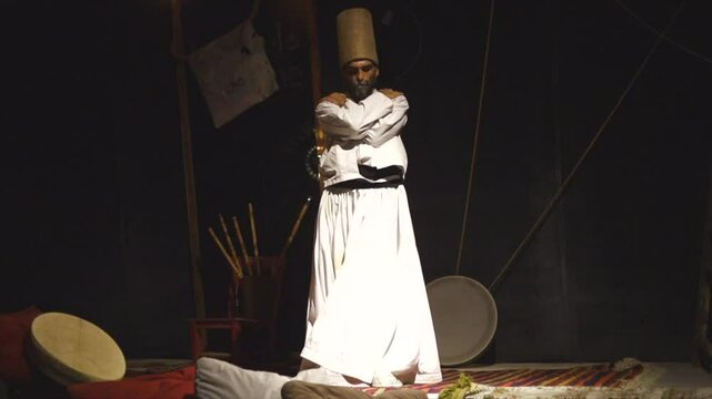 the image of a whirling Dervish in the darkness