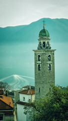 Scenic cityscape of Lugano with Cathedral of Saint Lawrence bell tower and lake view and dramatic...