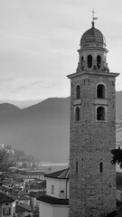 Scenic cityscape of Lugano with Cathedral of Saint Lawrence bell tower and lake view and dramatic...