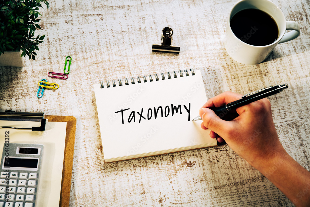 Poster there is notebook with the word taxonomy. it is as an eye-catching image.
