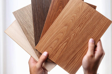close up of hands laminated samples, choice of laminated surface for the clipboard. imitation laminated wood in hands