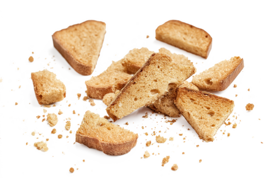 Close-up of light brown bread crumbs scattered on isolated background. Crumbs are in various directions, creating randomness. No text or objects visible. Crumbs are isolated, with no clear definition.