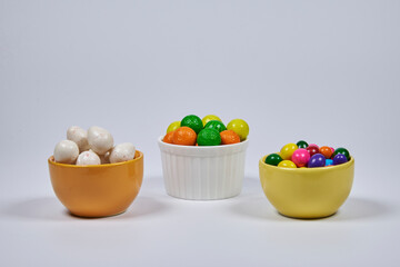 Gumballs of different colors and flavors representing fruits such as watermelon, lemon, orange, melon