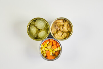 Very colorful canned vegetables, in a zenithal or top shot with a white background and space for text