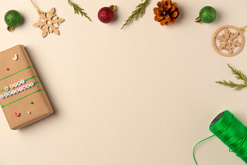 Christmas frame on beige background. Flat lay, top view. Copy space