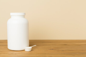 Jar with protein powder on table. Sports nutrition concept