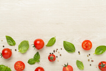 Fresh tomatoes, basil, sea salt and spices on wooden background, top view