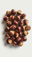 Top view of raw, shelled chestnuts on neutral background for fall snack