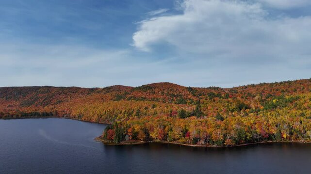 Beautiful scenery of autumn fall foliage colors inside Cape Breton Islands National Park. Warren Lake, Ingonish. Autumn colors of Cape Breton, Nova Scotia. Cabot Trail fall foliage landscape hiking. 