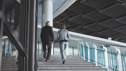 businesspeople are walking up the stairs