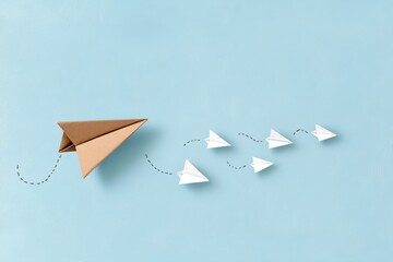 Brown Paper Airplane Leading the Way Through a Line of Airplanes - Paper Art - Aviation and Education Industrie