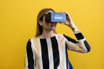 Young woman wearing a virtual reality device, viewing a virtual world in augmented reality....