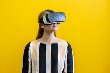 Young woman wearing a virtual reality device, viewing a virtual world in augmented reality....