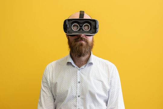 Man wearing a virtual reality device, viewing a virtual world in augmented reality. Using a hologram or head-mounted display visual device and interacting with the 3D world. Middle-aged male - Powered by Adobe