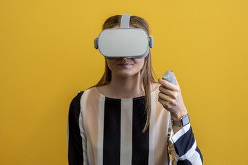 Young woman wearing a virtual reality device, viewing a virtual world in augmented reality....