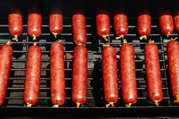 smoked sausages with red mahogany color in a collagen casing, in an offset smoker, closed up