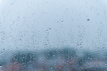 Water droplet on a glass window, rainy season concept