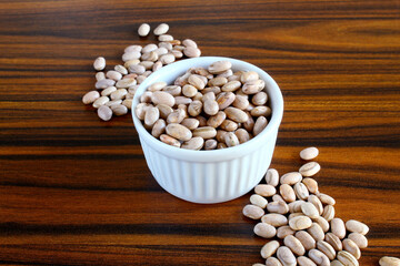 Carioca beans. Brazilian grains in a bowl on the rustic wooden table. Brazilian commodities.