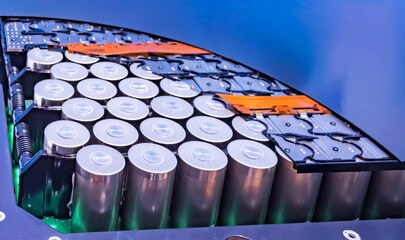 Metal parts with shiny steel cylindrical surface closeup. disassembled lithium ion form factor cell...