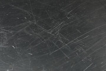 Texture of scratched metallic surface as background, closeup