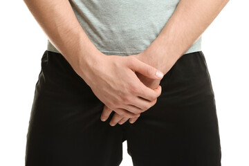STD (sexually transmitted diseases). Man suffering from symptoms on white background, closeup