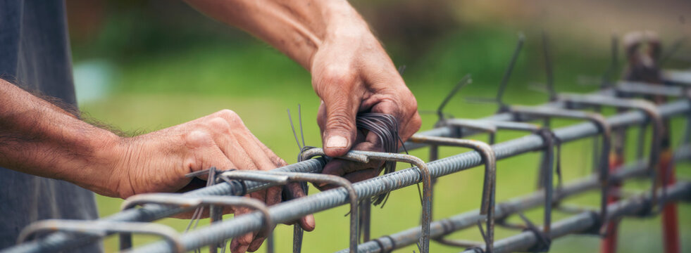 Banner Construction Worker hands using pincer pliers iron wire. Outdoor Worker using wire bending pliers. Banner Men hands bending cutting steel wire fences bar concrete worker with copy space