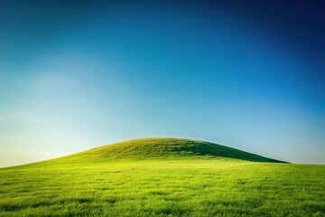 Obraz premium Scenic grassy hill with distant mountain